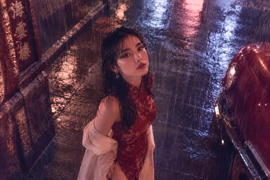 a woman stands in the pouring rain.